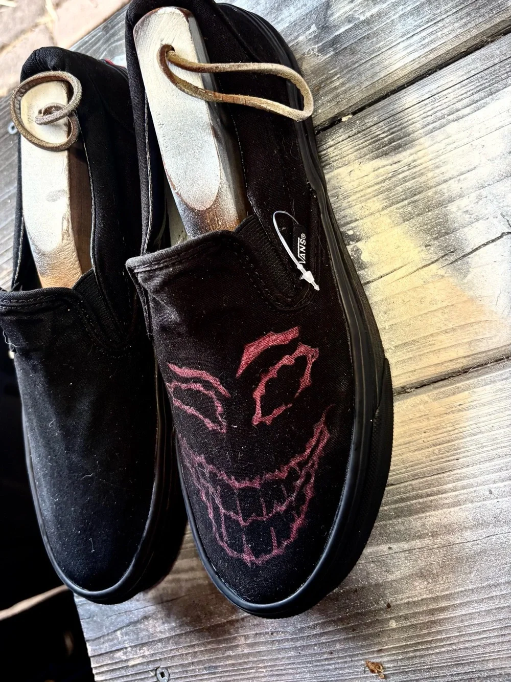 Vans black slip-on canvas sneakers with red hand-painted smiley face